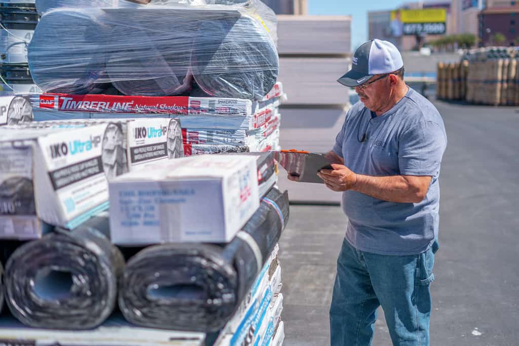 Delivery Promise - ABC Supply Yard Worker Reviewing Order