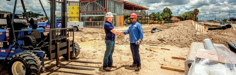 Two Men Shaking Hands on a Job Site
