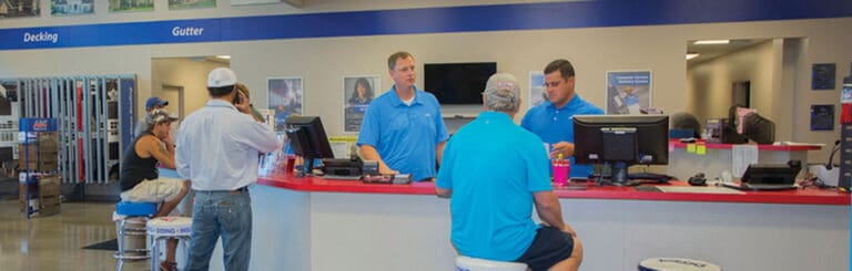 ABC Supply Mangers Helping Customers at a Customer Service Desk